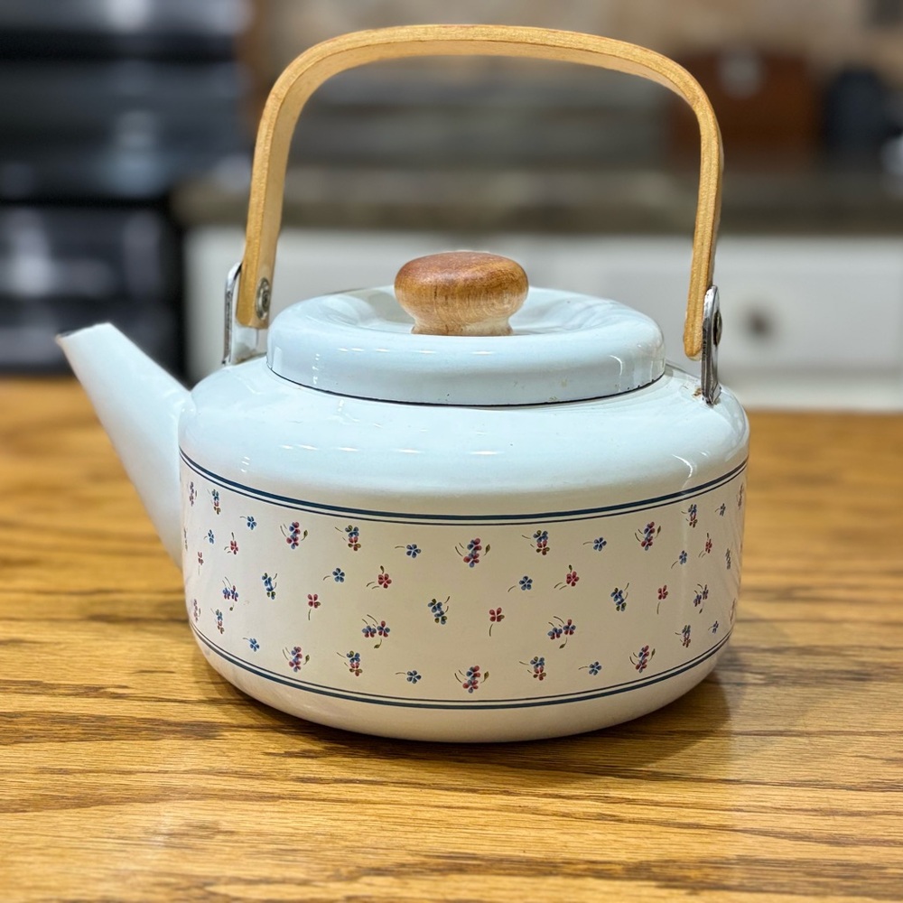 vintage white enamelware teapot, likely from the 1980s with wooden handle